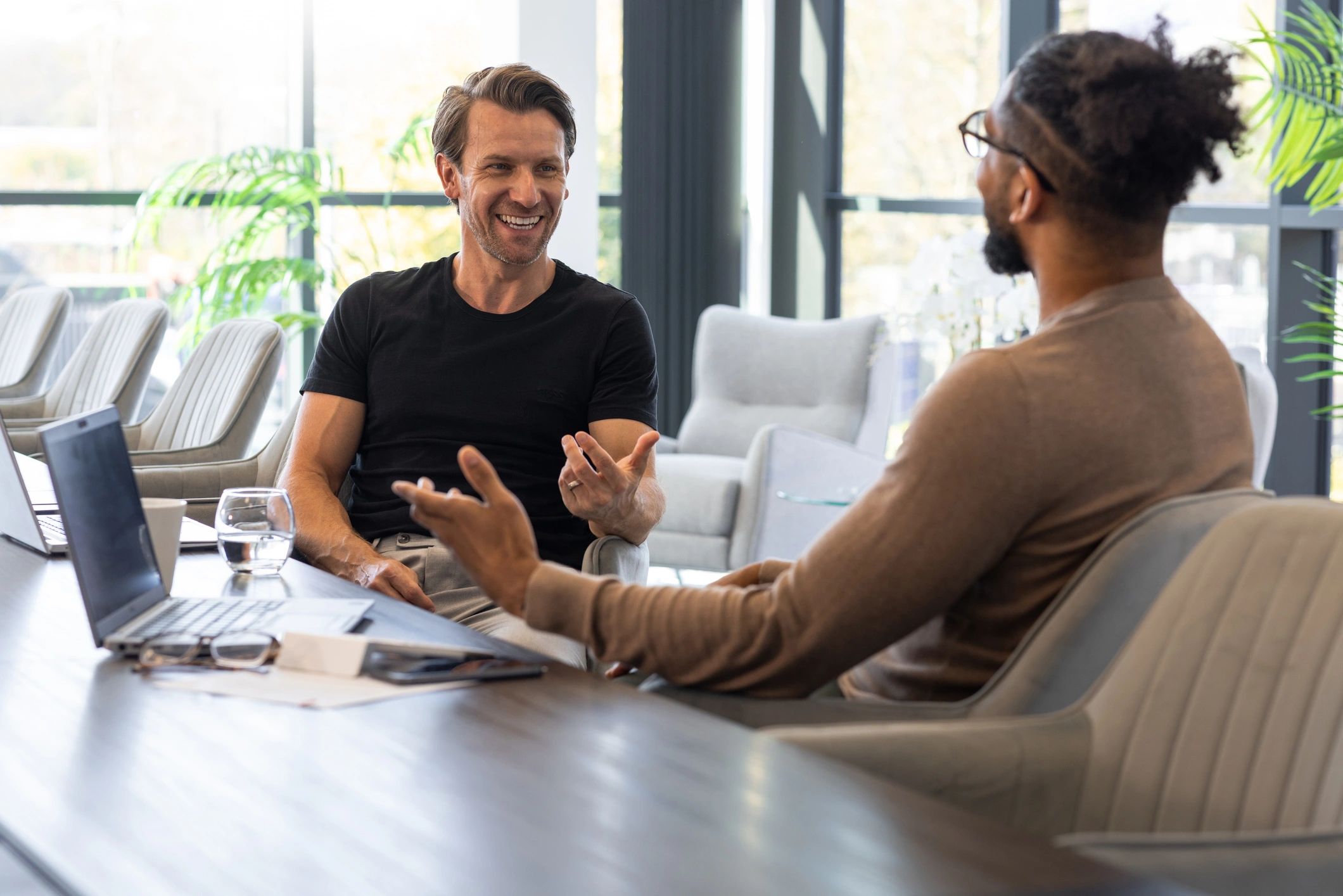 Dos profesionales conversando en una reunión de asesoría financiera
